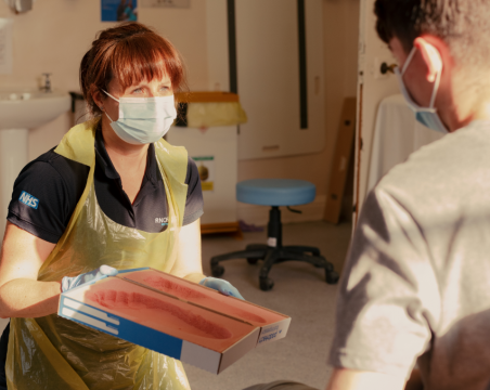 nurse with folder talking to patient
