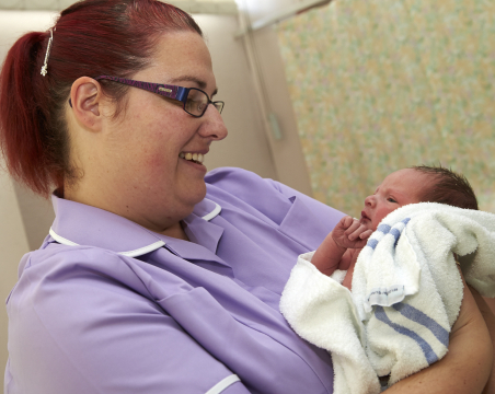 midwife holding baby