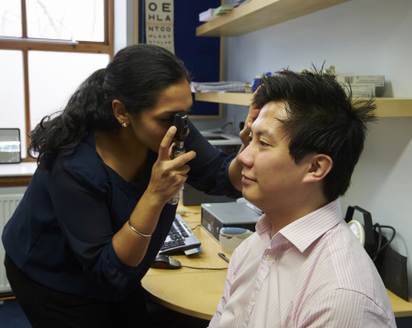 GP looking in eye of patient