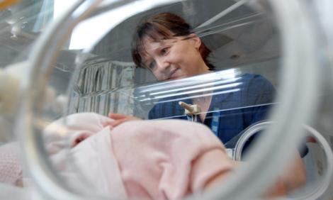 Neonatal nurse with baby