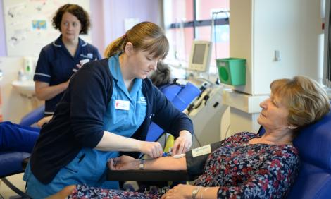Donor carer with volunteer donating blood