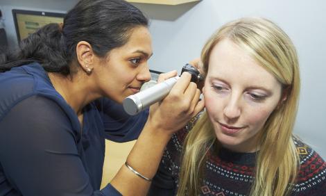 GP checking patients ear GP checking patients ear