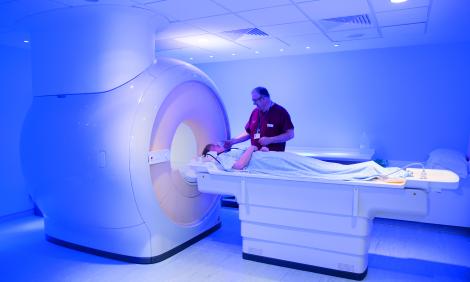 Staff member with patient going in scanner