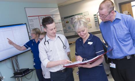 Male doctor with nurse and consultant