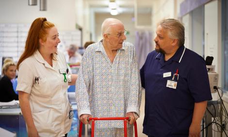 two adult nurses with patient