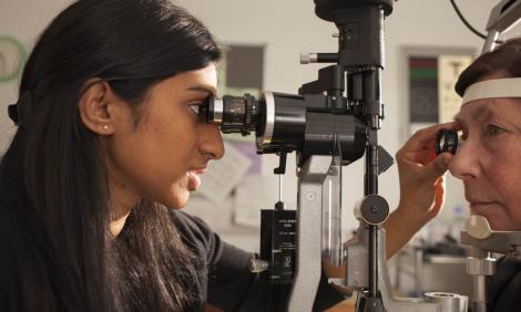 Female ophthalmologist checking eye