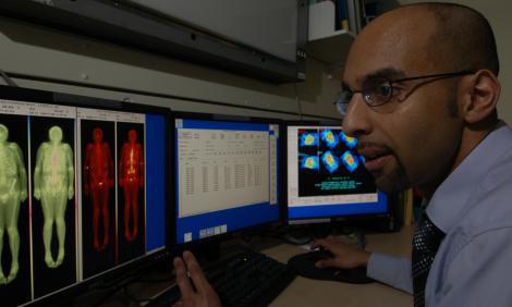 healthcare-science-male-examining-photos-gamma-camera