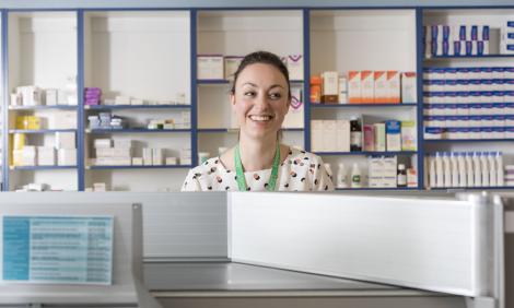 pharmacist smiling from behind counter