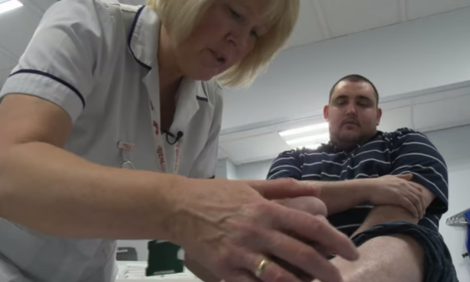podiatry assitant with patient
