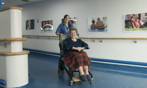 porter pushing person in wheelchair