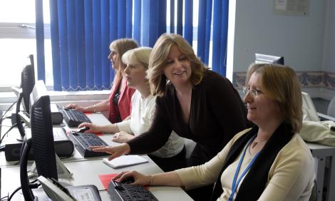 woman training people with computers woman training people with computers