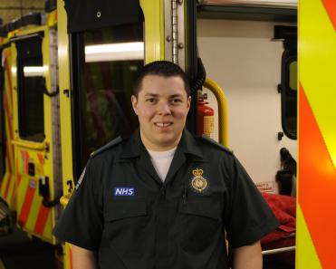 Male-ambulance-worker-with-ambulances