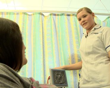 Maternity support worker with patient