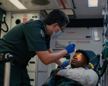 paramedic in ambulance with patient