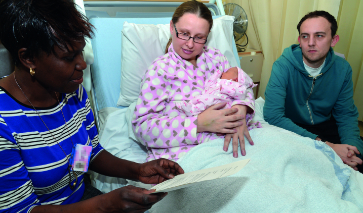 Midwife with parents and child Midwife with parents and child