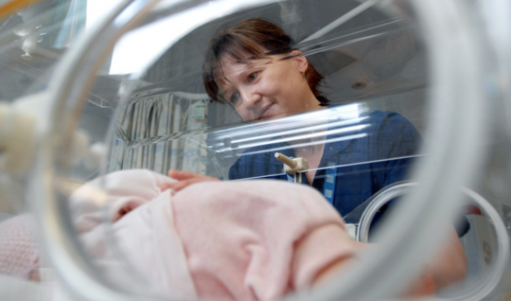 Neonatal nurse with baby
