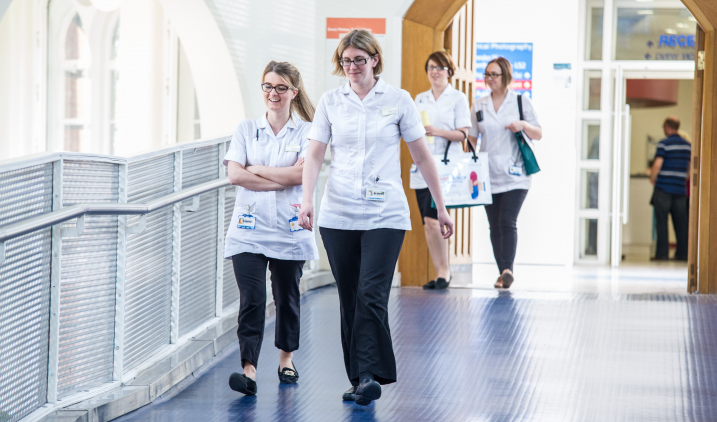 Physiotherapists walking in corridor Physiotherapists walking in corridor