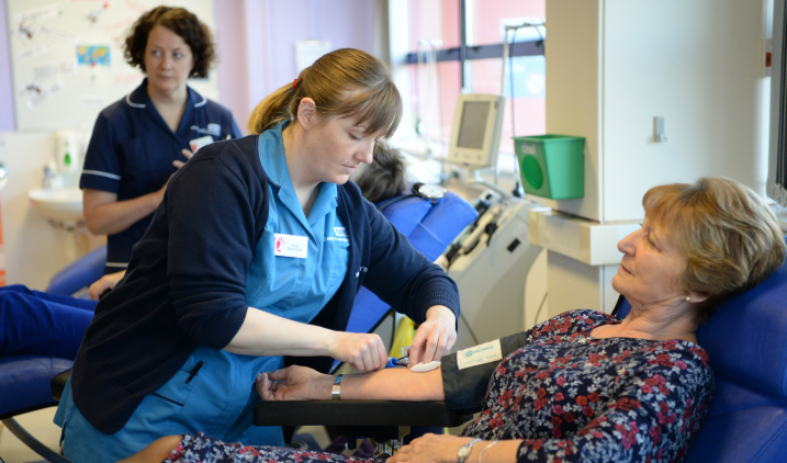 Donor carer with volunteer donating blood