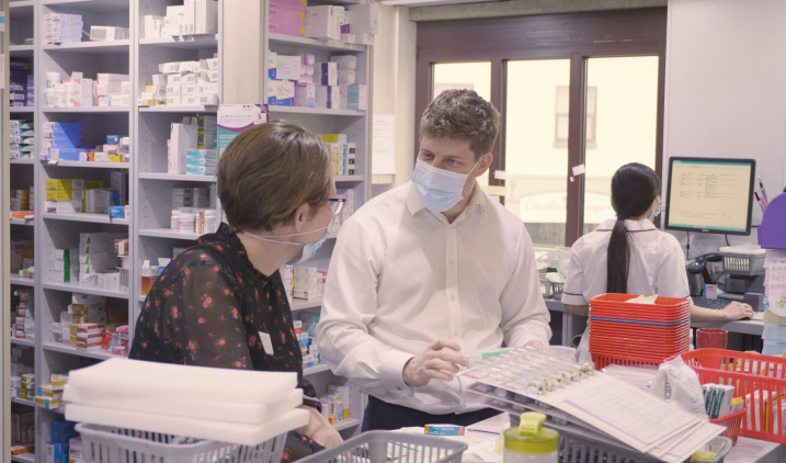 pharmacy technician talking to colleague