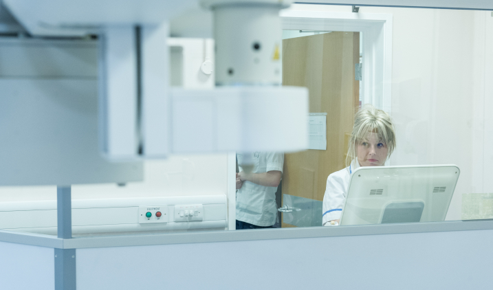 Female member of staff with scan equipment Female member of staff with scan equipment