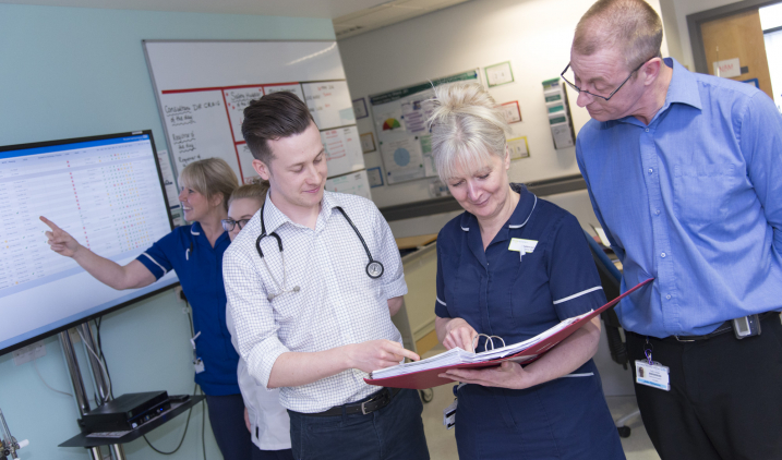 Male doctor with nurse and consultant