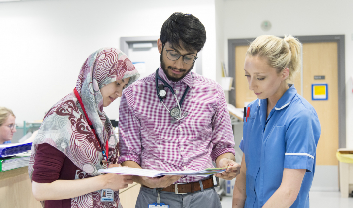 Male doctor with two colleagues Male doctor with two colleagues