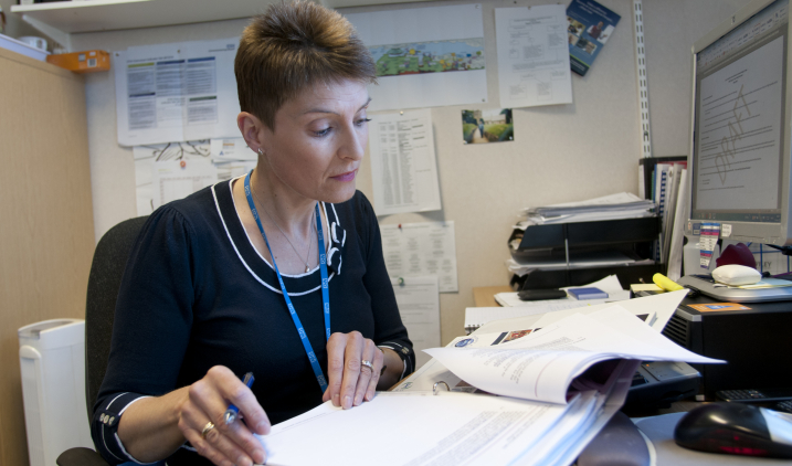 Manager looking at paperwork Manager looking at paperwork