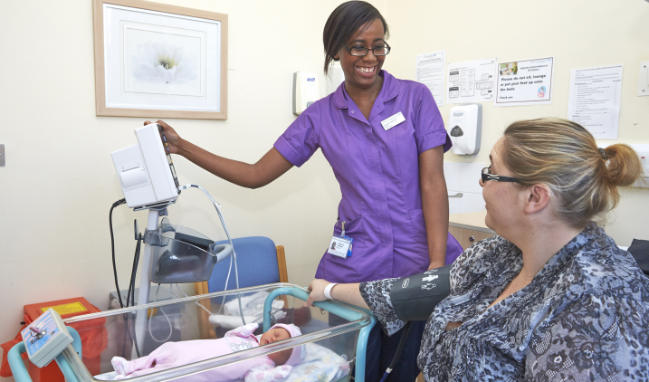 Midwife and new mum smiling Midwife and new mum smiling
