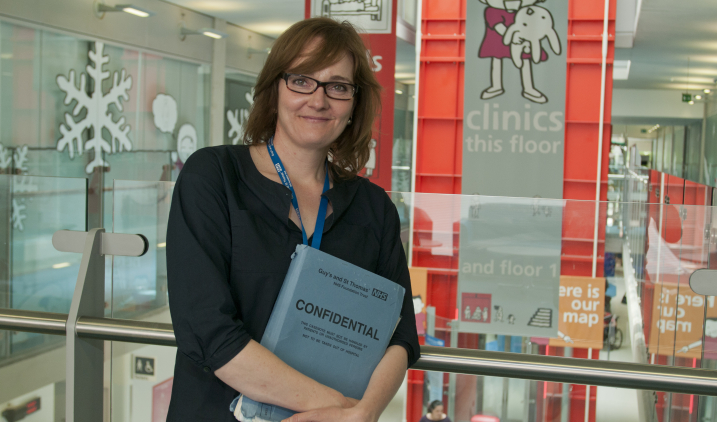 Staff holding confidential folder Staff holding confidential folder