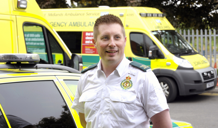 Paramedic in front of ambulance