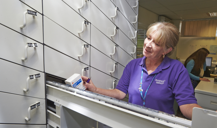 Pharmacist opening tablet draw Pharmacist opening tablet draw