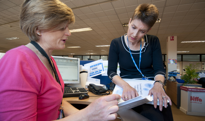 Staff looking through folders