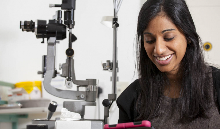 doctor smiling while looking at ipad doctor smiling while looking at ipad