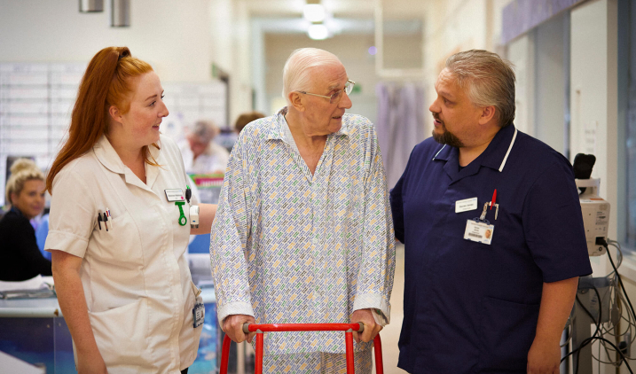 two adult nurses with patient