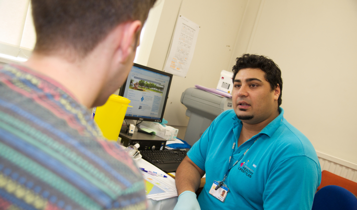 Community and sexual health doctor with patient