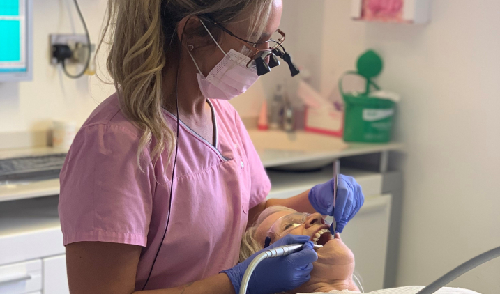 dental hygienist with patient