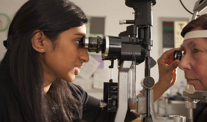 Female ophthalmologist checking eye