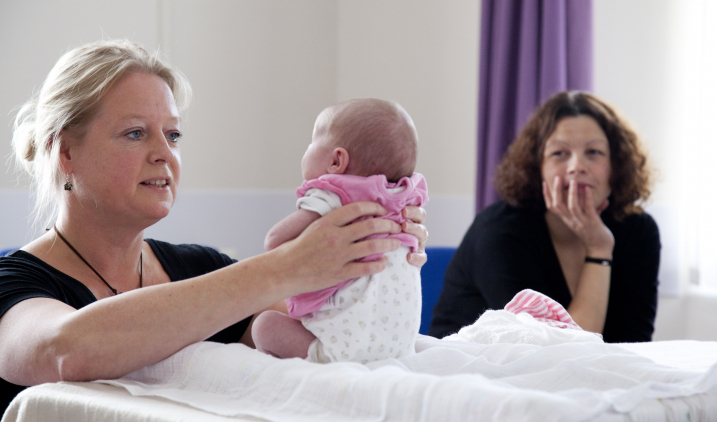 health visitor holding baby