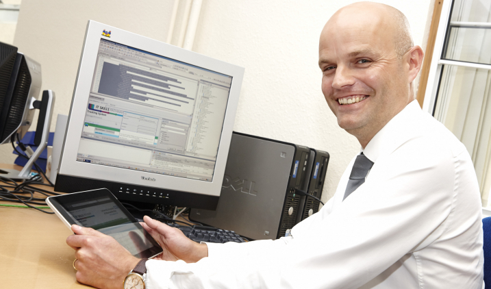 health-informatics-man-with-computer-and-ipad