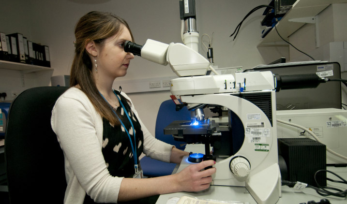 healthcare-science-female-looking-through-telescope-2 healthcare-science-female-looking-through-telescope-2