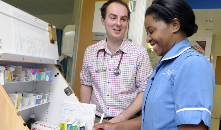 male doctor and female nurse laughing male doctor and female nurse laughing