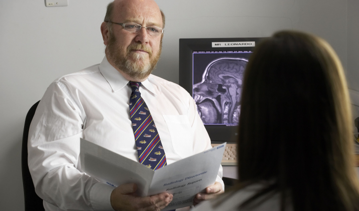male radiologist with patient in office male radiologist with patient in office