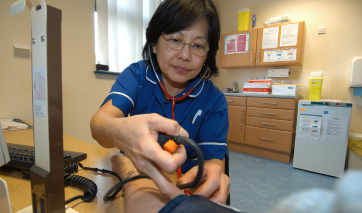 Practice nurse with BP checker Practice nurse with BP checker