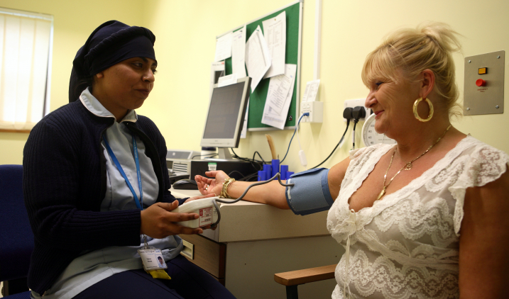 physiotherapy assistant holding a patient's hand physiotherapy assistant with patient