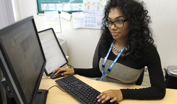Female member of staff with computer Female member of staff with computer