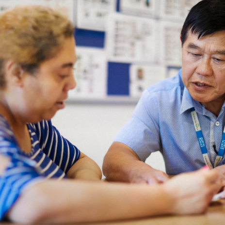 nurse with client writing