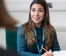 Psychological wellbeing practitioner talking to colleague